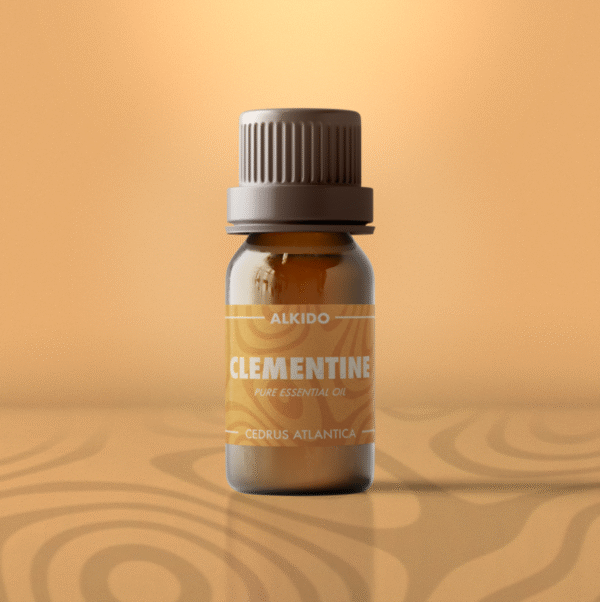 ALKIDO Clementine Pure Essential Oil in amber 10ml bottle with warm orange label and citrus swirl design, displayed on a glowing orange background.