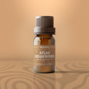 ALKIDO Atlas Cedarwood Organic Essential Oil in amber 10ml bottle with warm tan label on muted sand background.