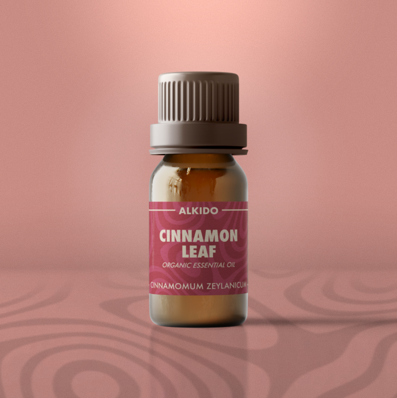 ALKIDO Cinnamon Leaf Organic Essential Oil in amber 10ml bottle with pink-red label on soft terracotta background.