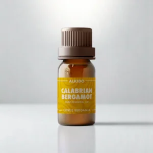 ALKIDO Calabrian bergamot pure essential oil in an amber glass bottle with a green label and brown cap on a light background