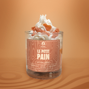 ALKIDO LE PETIT PAIN soy wax candle in a dessert style glass with whipped wax and sculpted bread topping on a warm orange background