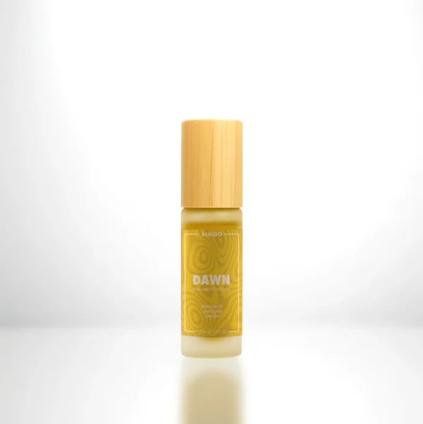 ALKIDO DAWN Nail and Cuticle Oil in a bamboo roller bottle with a yellow label on a light background