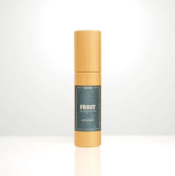 ALKIDO FROST Nail and Cuticle Oil in a bamboo roller bottle on a light background