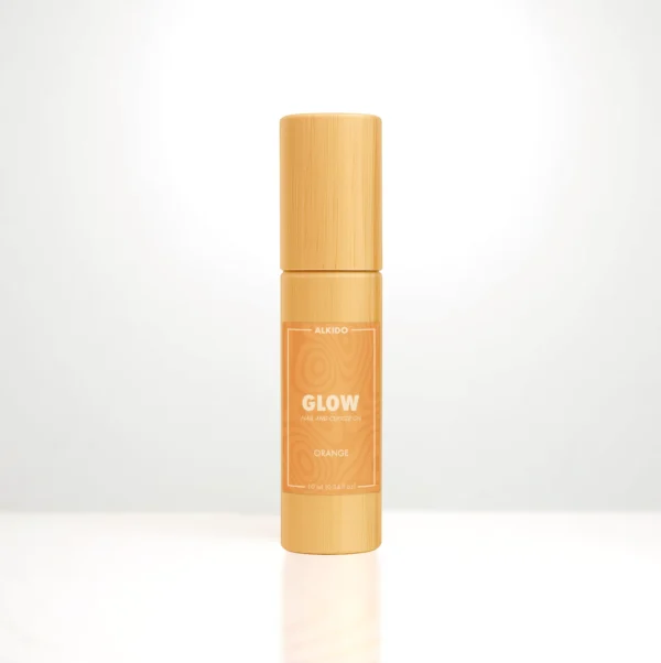 ALKIDO GLOW Nail and Cuticle Oil in a bamboo roller bottle with an orange label on a light background