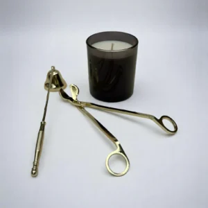 ALKIDO Candle Care Set gold Edition with black candle, wick trimmer, snuffer on a light background