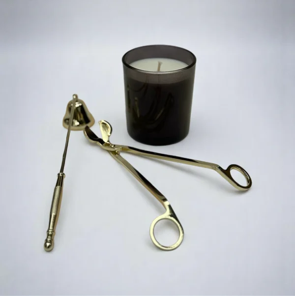 ALKIDO Candle Care Set gold Edition with black candle, wick trimmer, snuffer on a light background