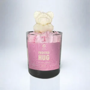 ALKIDO Frosted Hug soy wax candle in a glass jar with pink whipped topping and a bear-shaped decoration on a light gradient background