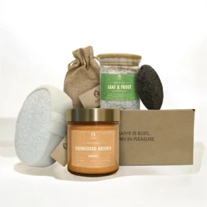 ALKIDO Sunkissed glow try it all set with scrub jar, bath sponge, lava stone, linen pouch, bath salt jar, and branded box on a light background