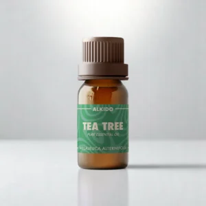 ALKIDO Tea Tree pure essential oil in an amber glass bottle with a green label and brown cap on a light background