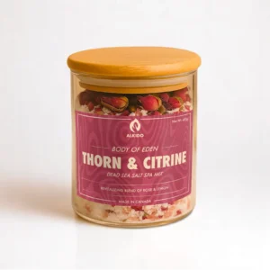 ALKIDO Thorn Citrine spa salt mix in a clear glass jar with a wooden lid and red label, topped with dried rose petals, on a light background