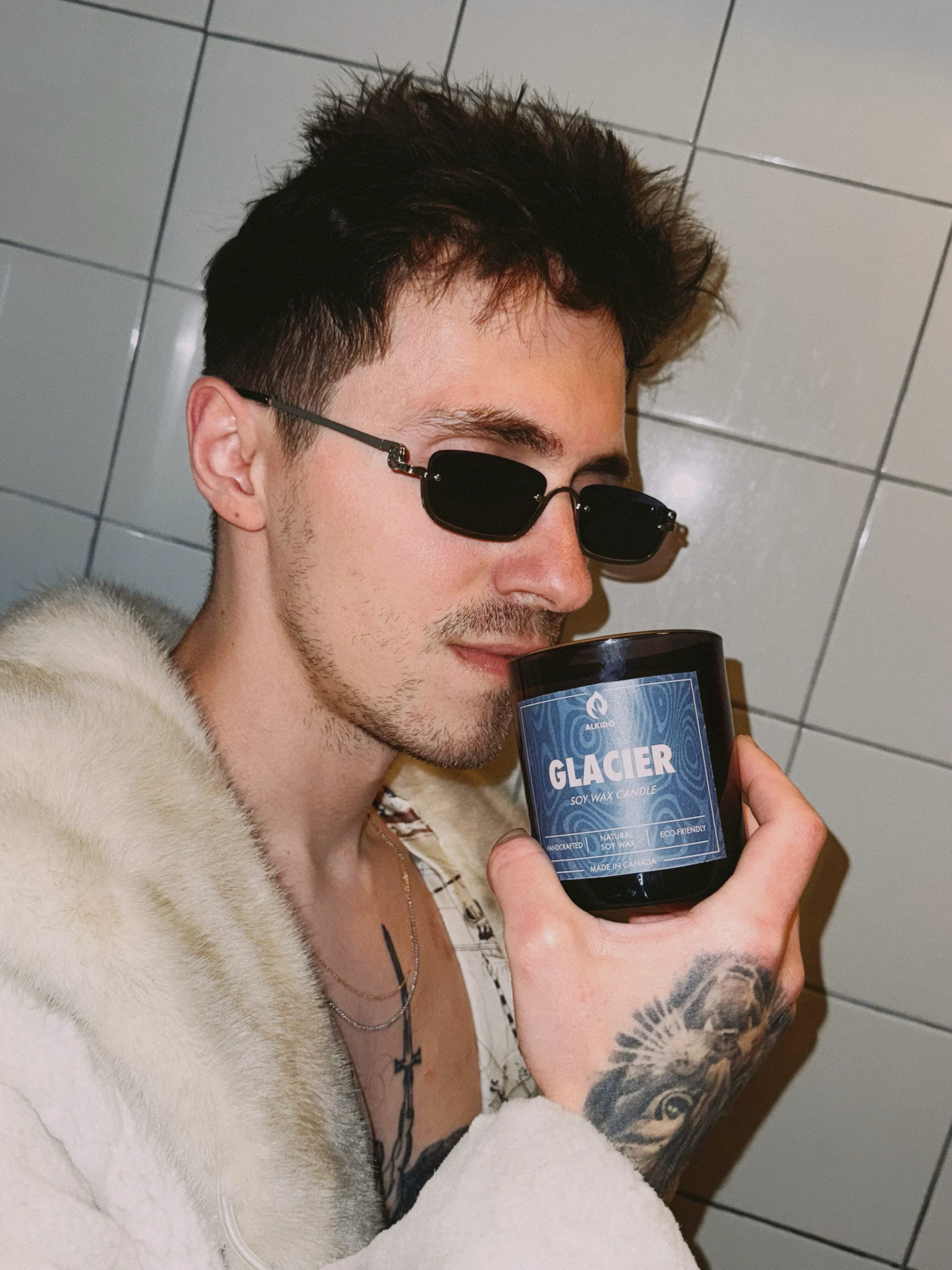 male model close up holding the glacier candle