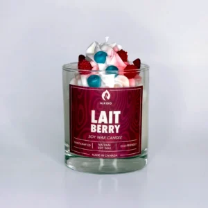 Decorative candle with berries decor on top and a red label