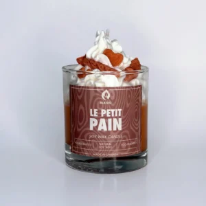 Decorative candle with a bread decor on top and a brown label