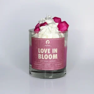 Decorative candle with a hearts on top and a pink label