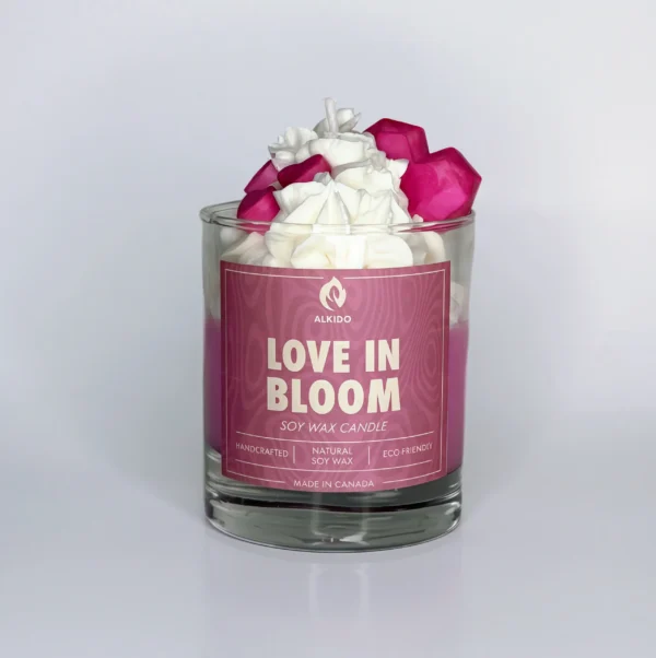 Decorative candle with a hearts on top and a pink label